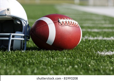 American Football And Helmet On The Field