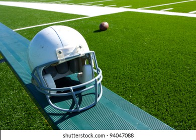 American Football Helmet On The Sideline Bench With Field In The Background