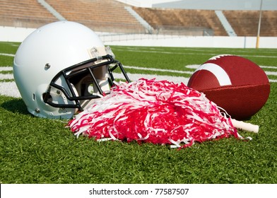 American football, helmet, and pom poms on field in stadium. - Powered by Shutterstock