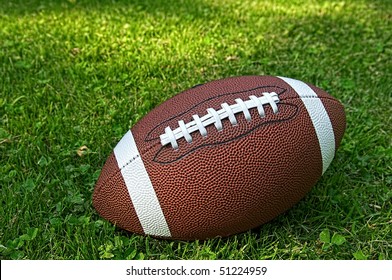 American Football Isolated Laying In The Summer Grass