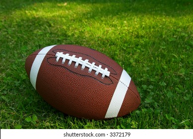 American Football Isolated On Top Of Green Grass