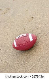 A American Football On The Beach In The Rain