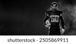 American football player banner on black background. Template for sports ads with copy space. Black and white photo