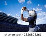 American Football Player catching a pass during a game. View from below as he tries to score a touchdown