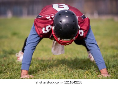 american football player doing push ups during training at the field - Powered by Shutterstock