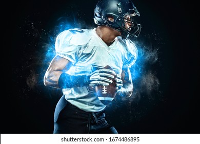 American football player in helmet with ball in hands. Fire background. Team sports. Sport wallpaper.