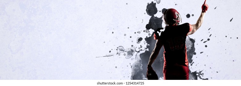 American football player in helmet pointing upwards against grey vignette - Powered by Shutterstock