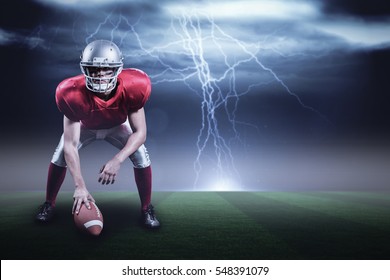 American football player holding helmet against stormy dark sky with lightning bolts with copy space 3d - Powered by Shutterstock