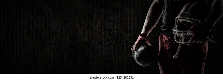  American football player holding rugby helmet and rugby ball against brown textured background American football player holding rugby helmet and rugby ball, Close-up - Powered by Shutterstock