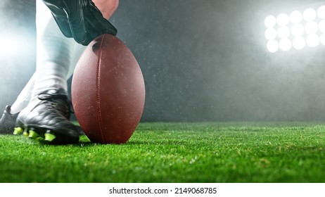 American football player kicking ball on grass., detailed shot. Football background. - Powered by Shutterstock