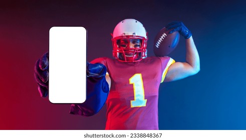 American Football Player. Mobile Phone App Advertisement. Sports Betting on American Futball. Bets Application. Handsome Man Showing At White Empty Smartphone Screen. Cellphone Display Mock Up - Powered by Shutterstock