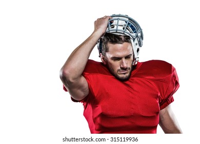 American football player in red jersey removing helmet against white background - Powered by Shutterstock