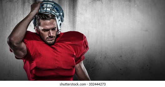 American football player in removing helmet against grey background - Powered by Shutterstock