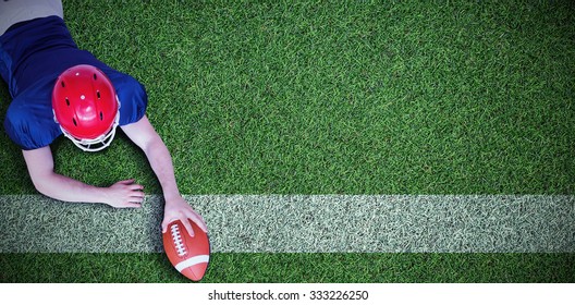 American football player scoring a touchdown against pitch with line
