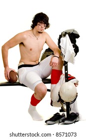 American Football Player. Seated On Weight Bench, Partially Undressed After Game.