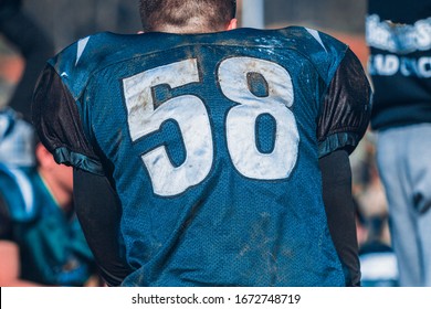 American football player seen from behind with number 58 and blue shirt - Powered by Shutterstock