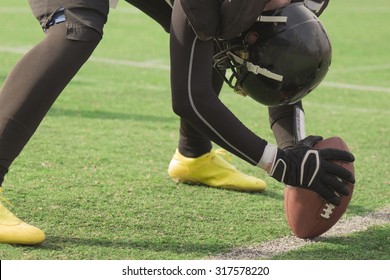 American football player setting up to snap the ball - Powered by Shutterstock