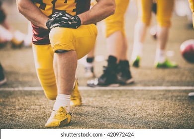 American football player stretching before entering the game. - Powered by Shutterstock