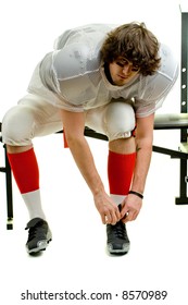 American Football Player. Tying Shoe On Weight Bench.