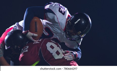 American Football Players In Action At Night Game Time On The Field