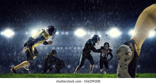 American Football Players At Arena . Mixed Media