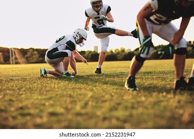 American Football Players Doing Place Kicking Drills Together On A Sports Field During A Team Practice In The Afternoon
