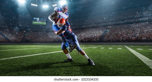 American football players preforms an action play in professional sport stadium
