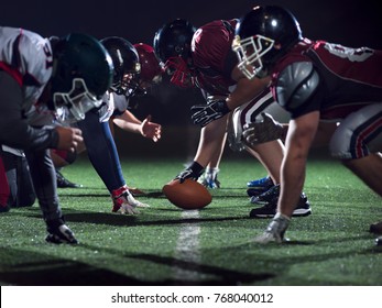 american football players are ready to start on field at night - Powered by Shutterstock