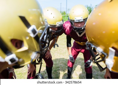 American Football players at strategy huddle - Shutterstock ID 342578654