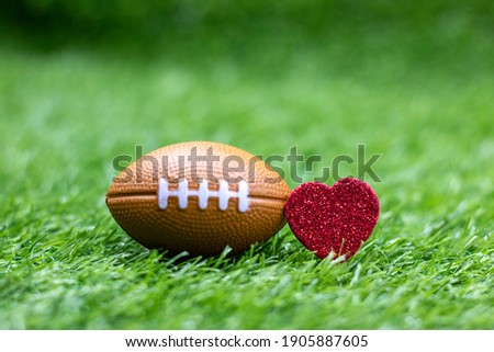 American football with red heart for Valentine's Day concept