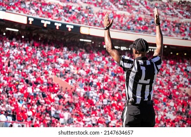 American Football Referee Official Signals A Touchdown In A Large Football Stadium.	