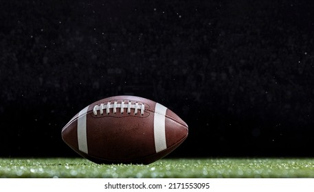 American Football resting on the field of a Football stadium during a game. Copy space and good football abstract photo - Shutterstock ID 2171553095