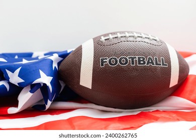 American football rugby ball against american flag - Powered by Shutterstock