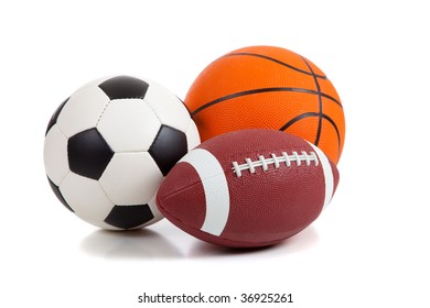 An American Football, A Soccer Ball And A Basketball On A White Background