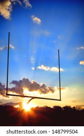 American Football Sport Stadium Goal Posts In End Zone Over Dramatic Blue Sky During A Spectacular Sunset