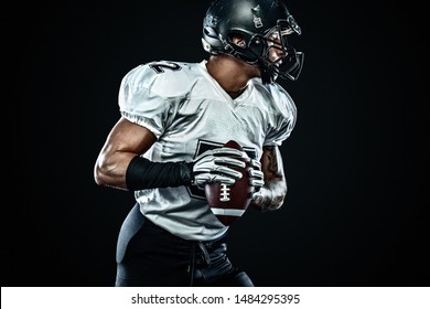 American football sportsman player in helmet on black background. Sport and motivation. Team sports.