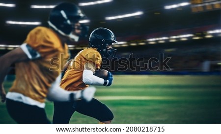 American Football Stadium Field Two Teams Compete: Successful Player Running to Score Touchdown Points. Professional Athletes Compete for the Ball, Tackle, Fight for Championship Victory.