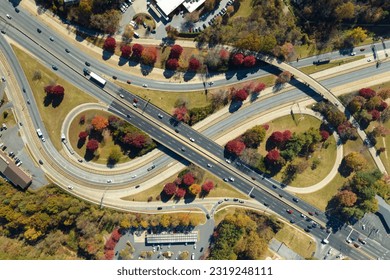 American freeway intersection with fast driving cars and trucks. View from above of USA transportation infrastructure