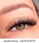 The American girl has green eyes and Classic eyelash extensions that look very natural. Eyelash extension