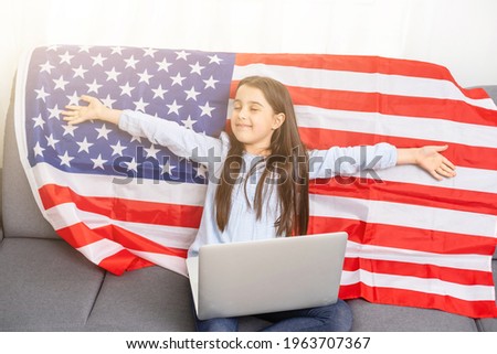 American girl looks online news. news. Flag Day. Independence Day of America.