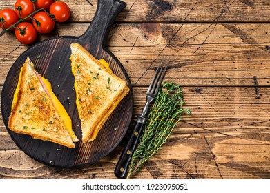 American ham and melted cheese sandwich. wooden background. Top view. Copy space