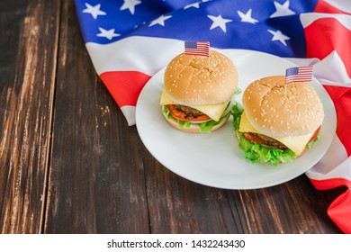 American Hamburger Or Cheeseburger With America Flag For USA 4th Of July Independence Day Food Background Concept