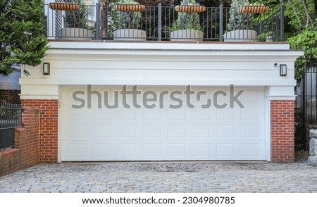 American home garage and driveway symbolize convenience, transportation, and personal space. They represent the ownership of vehicles, storage, and the entrance to one's private domain