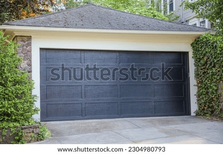American home garage and driveway symbolize convenience, transportation, and personal space. They represent the ownership of vehicles, storage, and the entrance to one's private domain