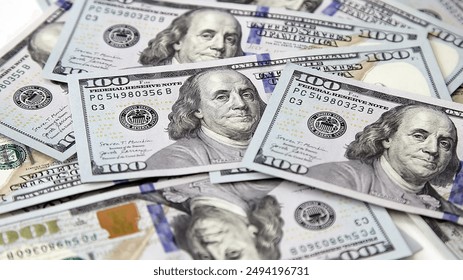 American hundred dollar paper money lies on the office table. Close-up of 100 American dollar bills. Currency exchange one hundred dollars. Investment, finance and income concept.