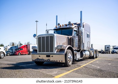 American idol coffee with milk big rig classic stylish semi truck tractor with extended long cab and chrome parts standing along on truck stop parking lot with another semi trucks and trailers - Shutterstock ID 2137396143