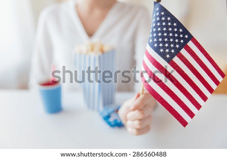 american independence day, celebration, patriotism and holidays concept - close up of woman hand holding flag at 4th july party