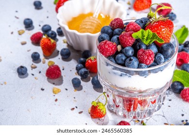 American independence holiday food, july 4 breakfast recipe idea. Summer diet healthy breakfast layered parfait dessert in a glass of yogurt, oatmeal, blueberries, strawberry berries - Powered by Shutterstock