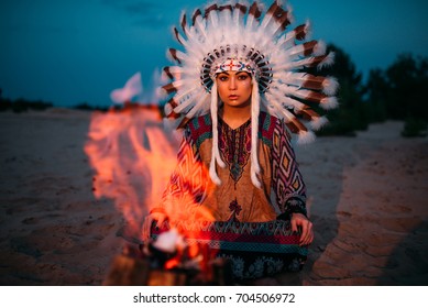 American Indian girl against bonfire, shaman