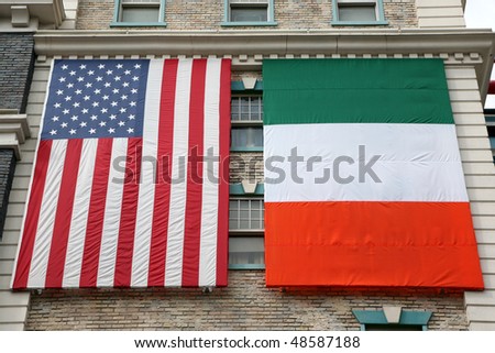 American and Irish flags hanging on an old building